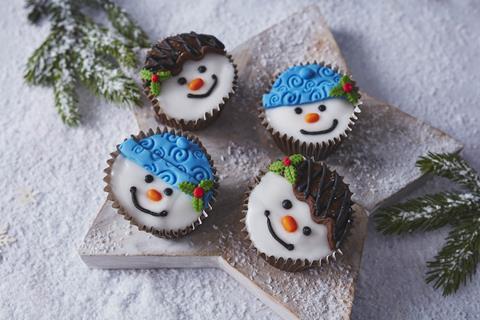 Four Snowman Cupcakes on a snowy background