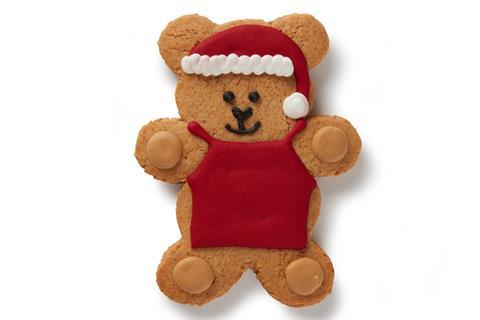 A gingerbread biscuit shaped like a bear, dressed up as a Starbucks barista