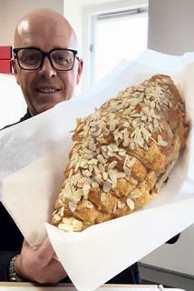 Coughlans Bakery - Giant almond croissant held by Coughlans MD Sean Coughlan - 2100x1400