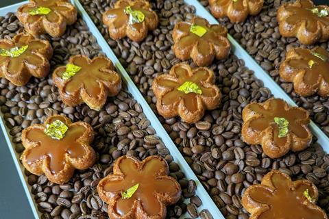 British Baker - Chamomile Flower and Black Tea Toffee served on a bed of coffee beans