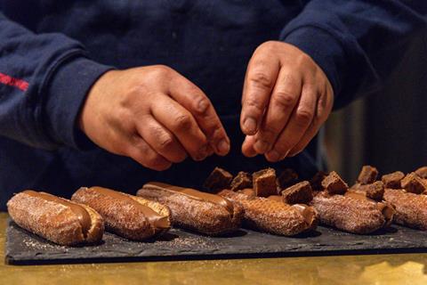 Close up shot of doughnuts being decorated