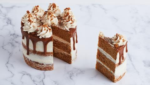 A blonde chocolate layer cake with swirls of buttercream on top