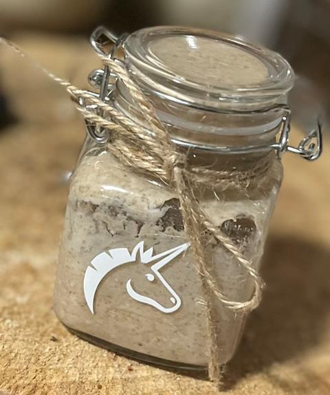 A rye sourdough in a small glass jar with twine