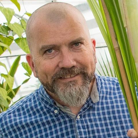 Dr David Bryant in a blue & white chequered shirt