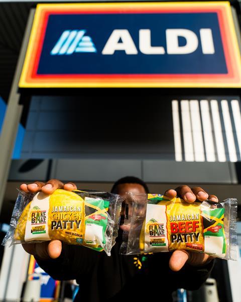 Flake Bake - Flake Bake co-founder Mike Williams holds up the new Chicken Patty and original Beef Patty in front of an Aldi store