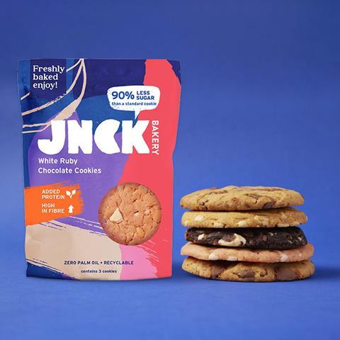 Jnck Bakery packaging and stack of cookies on a blue background
