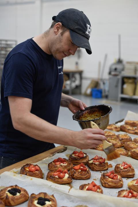 Steven Winter glazing fruit pastries at Bread Source