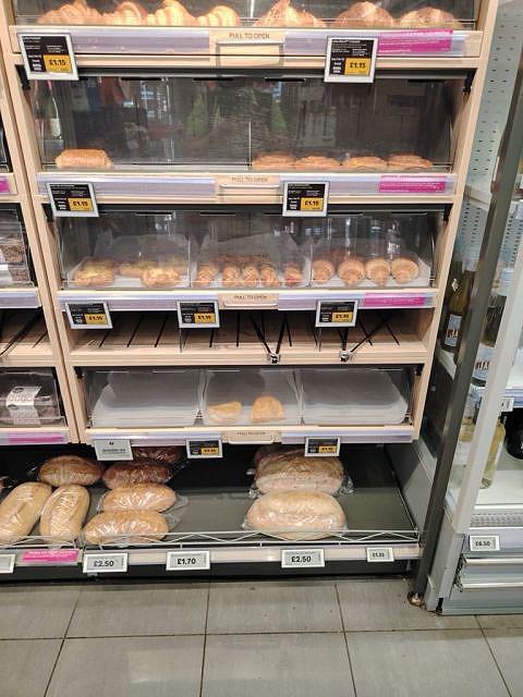 Asda - In-store bakery fixture at an Asda Express store featuring updated electronic signage