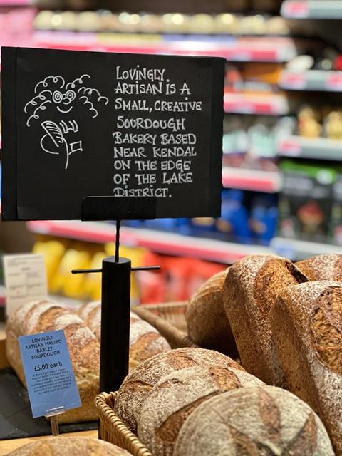 An array of lovely looking sourdough loaves with a sign for Lovingly Artisan bakery next to them