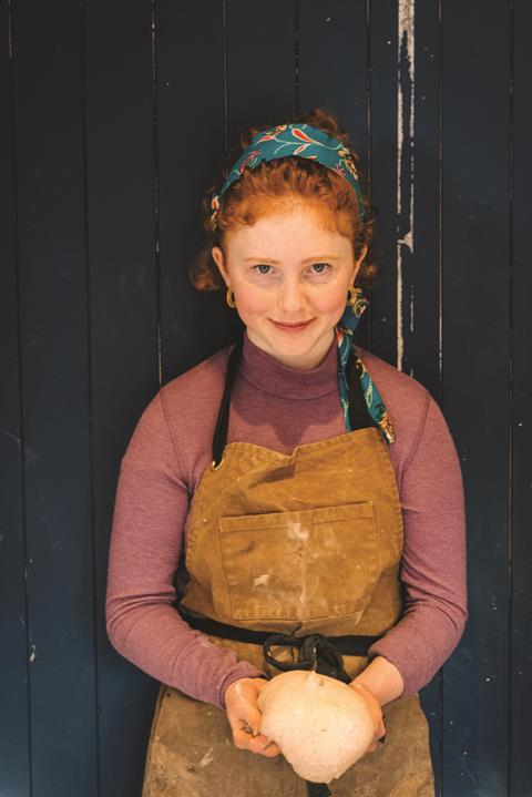 Kitty Tait Orange Bakery holding bread