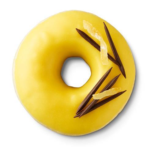 A yellow ring doughnut with yuzu and dark chocolate on top