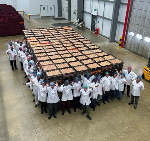 Guenther Bakeries staff stand by a large batch of rolls produced at the new Lyons 106 site in Coventry.