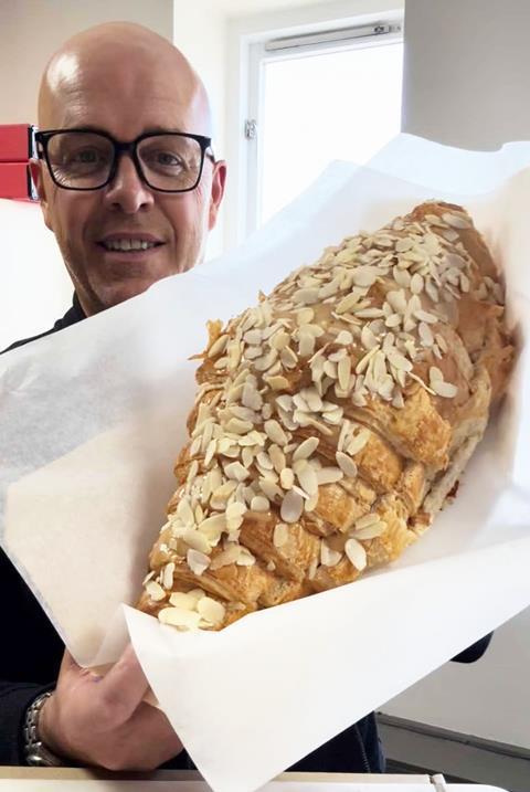 Coughlans Bakery - Giant almond croissant held by Coughlans MD Sean Coughlan - 2100x1400