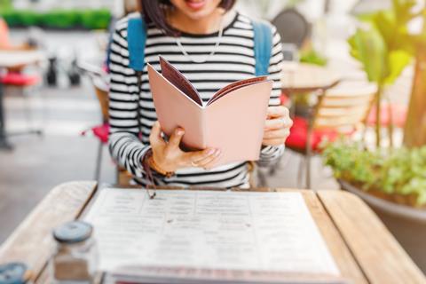 Woman reading menu at restaurant