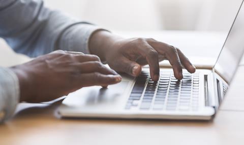 Hands typing on a keyboard