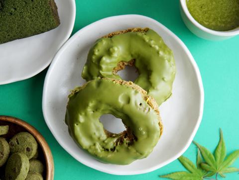 A doughnut shaped biscuit with matcha icing on top