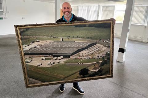 I.T.S - Founder Mike Bagshaw holds up a framed photo of the newly purchased site near Hungerford - 2100x1400
