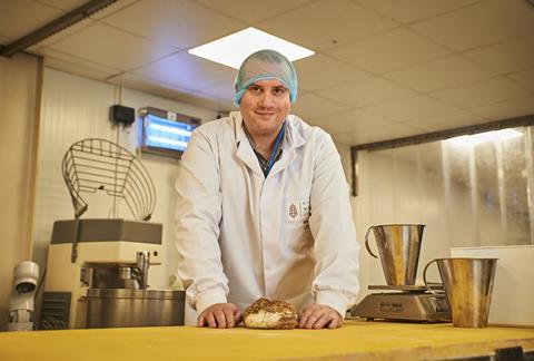 William Leet in a blue hair net and white baker's jacket