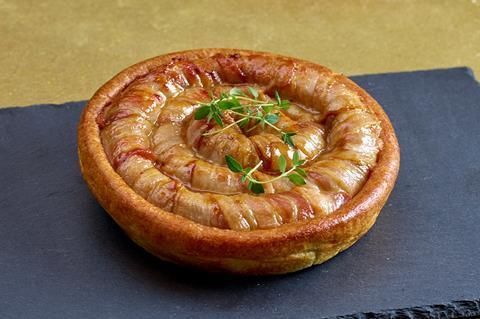 A giant pig in blanket in a Yorkshire pudding