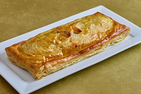 Large sausage roll on a white plate