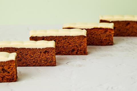 Square slices of banana cake with cream cheese frosting on top