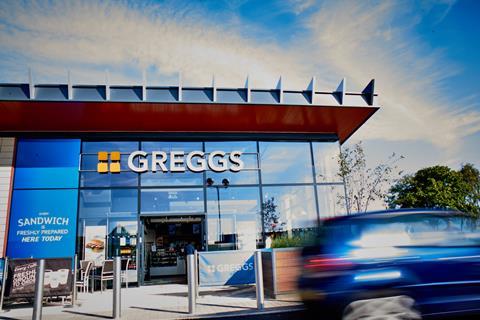 Greggs store with car driving by