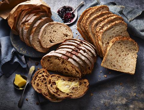 Three slices loaves on blue fabric with a pot of jam