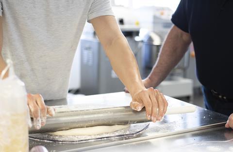 A person rolling dough