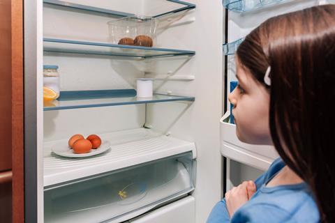 Girl looking into empty fridge