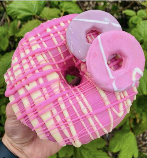 A giant pink doughnut with Party Rings biscuits on top