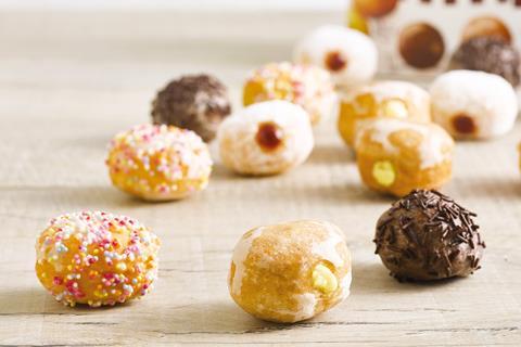 Small doughnuts with sprinkles on and jam in