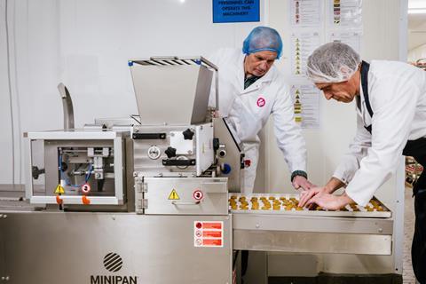 The Barking Bakery - Production staff work on a line making new doggy biscuits
