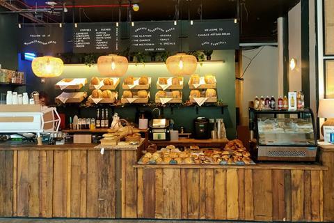 A A selection of sourdough loaves and handmade pastries on display in a bakery