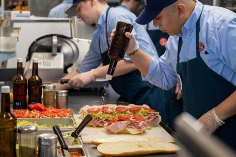 Jersey Mike's Subs - A worker prepares a fresh sandwich - 2100x1400