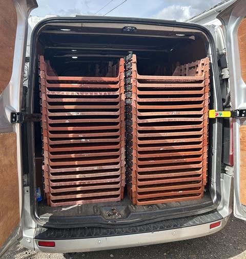 Bread baskets stacked up in the back of a van