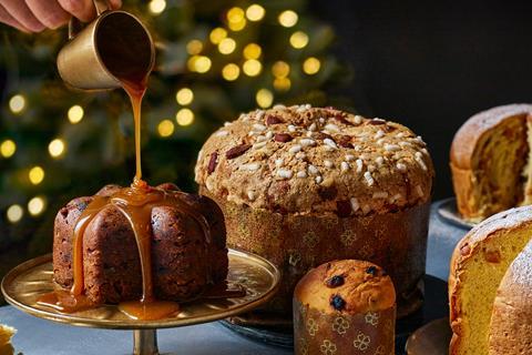 A sticky toffee panettone Christmas pudding with caramel sauce being poured over