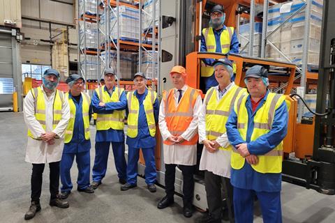 Carlisle MP John Stevenson (centre in orange) stands with Pladis employees during the opening of its new warehouse.  2100x1400