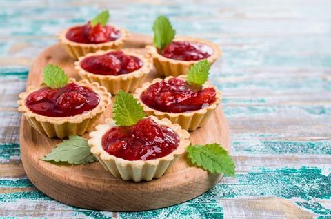 Jam tarts with whole fruit and mint leaves on top