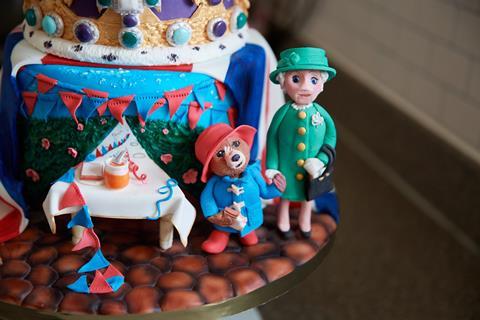 A royal cake with Paddington bear and the Queen on it