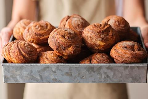 Cinnamon Buns In Tray Being Held Apron