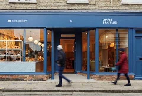 A person walking outside the Cornish Bakery