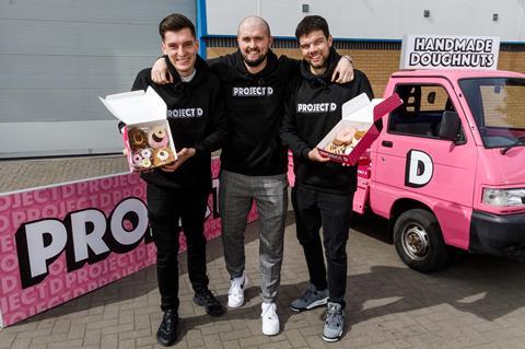 The Project D founders holding doughnuts