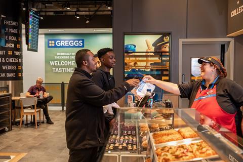 A happy shop assistant serving a customer in Greggs' Gatwick site
