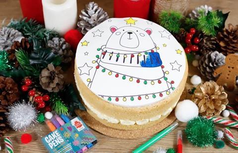 A Christmas cake with a bear drawn on the icing