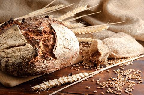 Loaf of sourdough with wheat on a hessian sack