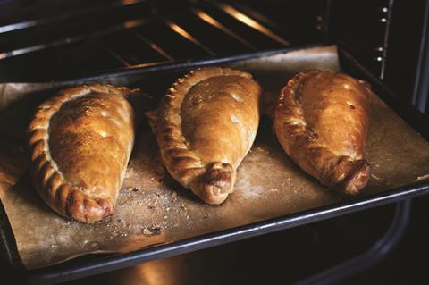 Three Cornish pasties on an oven tray