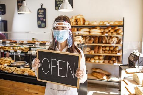 Woman working in bakery with mask on