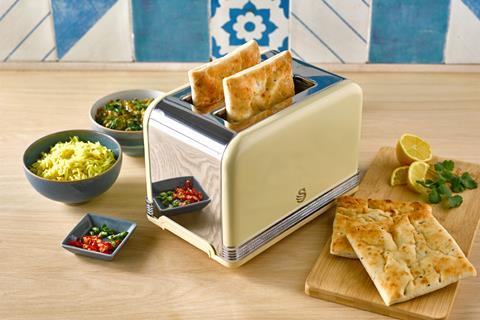 Soft naan breads in a toaster with bowls of dips around it