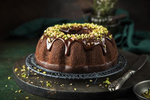 A chocolate cake topped with chocolate sauce and pistachio
