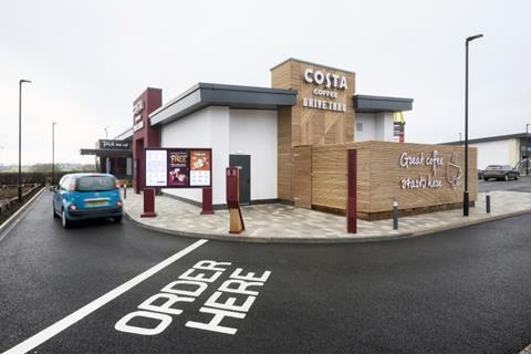 A car driving through a Costa drive-thru